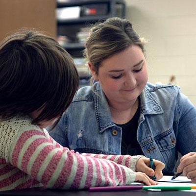 Teacher Coloring with a student